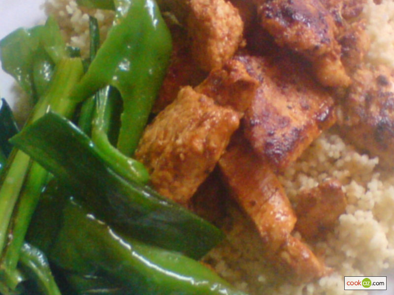 Peri peri chicken served with sauteed green bell pepper strips and cous-cous